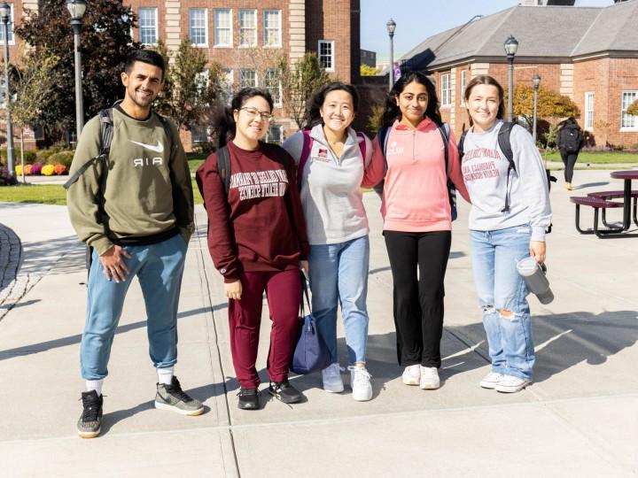 A group of ACPHS students stand together on campus